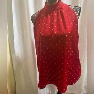 Red with white polka dots sleeveless top.